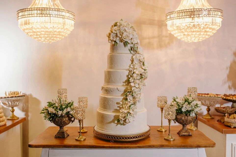 A wedding cake on a table with flowers on it